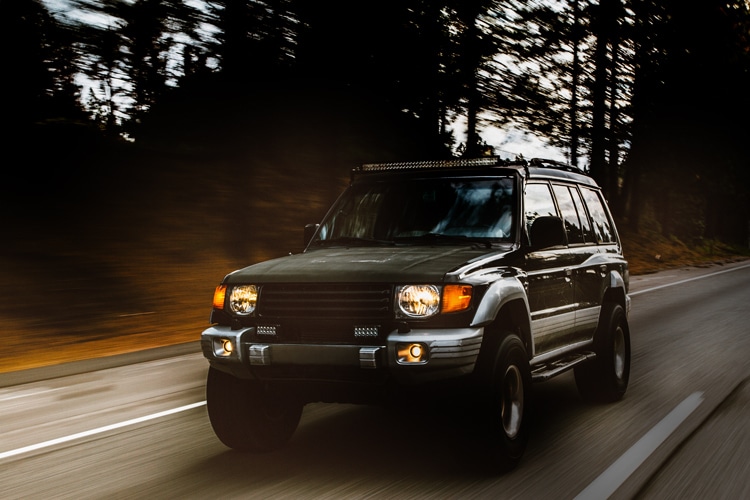 SUV motion traveling down road we buy used cars